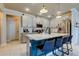 Island kitchen with white cabinets, stainless steel appliances, and bar stool seating at 2456 Arbor Wind Dr, Lutz, FL 33558