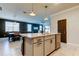 Open kitchen showcasing a kitchen island, stainless steel appliances, and dining area at 2456 Arbor Wind Dr, Lutz, FL 33558