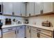 Kitchen featuring white cabinets, sleek countertops, and stainless steel appliances at 2456 Arbor Wind Dr, Lutz, FL 33558