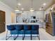 Island kitchen with white cabinets, stainless steel appliances, and bar stool seating at 2456 Arbor Wind Dr, Lutz, FL 33558