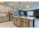 Island kitchen with white cabinets, stainless steel appliances, and open dining area at 2456 Arbor Wind Dr, Lutz, FL 33558