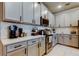 Kitchen featuring white cabinets, sleek countertops, and stainless steel appliances at 2456 Arbor Wind Dr, Lutz, FL 33558