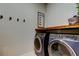 Modern laundry room with front-load washer and dryer set and functional decor at 2456 Arbor Wind Dr, Lutz, FL 33558