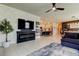 Open-concept living room showcasing a fireplace, television, and seamless flow into the kitchen at 2456 Arbor Wind Dr, Lutz, FL 33558
