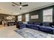 Spacious living room featuring tile floors, a large couch, and modern decor at 2456 Arbor Wind Dr, Lutz, FL 33558