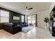Bright living room with a blue sofa, ceiling fan, and sliding glass doors to the patio at 2456 Arbor Wind Dr, Lutz, FL 33558