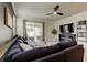 Comfortable living room with a sectional sofa, fireplace, and sliding doors to the patio at 2456 Arbor Wind Dr, Lutz, FL 33558