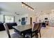 Open-concept living space connecting the dining and kitchen areas, featuring modern decor and tile flooring at 2456 Arbor Wind Dr, Lutz, FL 33558