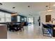 Open concept living and dining area with tile floors, large windows, and modern decor at 2456 Arbor Wind Dr, Lutz, FL 33558