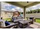Inviting covered patio with comfortable seating and a view of the backyard play area at 2456 Arbor Wind Dr, Lutz, FL 33558