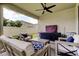 Cozy outdoor living space featuring comfortable seating, storage, and an expansive backyard view at 2456 Arbor Wind Dr, Lutz, FL 33558