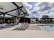 Luxurious community pool area with lounge chairs, covered seating, perfect for relaxation and recreation at 2456 Arbor Wind Dr, Lutz, FL 33558