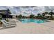 Inviting community pool area featuring lounge chairs, fountains, and well-maintained tile surroundings at 2456 Arbor Wind Dr, Lutz, FL 33558