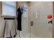 Detailed view of a glass-enclosed shower with white tiled walls and modern fixtures at 2456 Arbor Wind Dr, Lutz, FL 33558