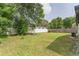 Large backyard with combination of wood and vinyl fencing and mature shade trees at 2606 E 97Th Ave, Tampa, FL 33612