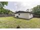 Spacious backyard with lush green lawn, providing ample space for outdoor activities and relaxation at 2606 E 97Th Ave, Tampa, FL 33612