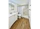 Modern bathroom featuring a sleek vanity, toilet, and a beautifully tiled walk-in shower with glass door at 2606 E 97Th Ave, Tampa, FL 33612
