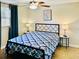 Comfortable bedroom with wood-look floors, ceiling fan, and ample closet space at 2606 E 97Th Ave, Tampa, FL 33612