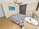 Comfortable bedroom with wood-look floors, ceiling fan, and tasteful decor at 2606 E 97Th Ave, Tampa, FL 33612