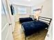 Cozy bedroom with two twin beds, wood-look floors and stylish decor at 2606 E 97Th Ave, Tampa, FL 33612
