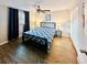 Comfortable bedroom with wood-look floors, ceiling fan, and ample closet space at 2606 E 97Th Ave, Tampa, FL 33612