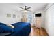 Comfortable bedroom with hardwood floors, soft natural light, and a ceiling fan at 2611 San Luis Rd, Holiday, FL 34691