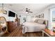 Bright bedroom with hardwood floors, stylish furnishings, and a ceiling fan at 2611 San Luis Rd, Holiday, FL 34691