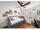 Cozy bedroom featuring a daybed, wood floors, and a ceiling fan at 2611 San Luis Rd, Holiday, FL 34691