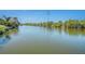 Peaceful waterfront view featuring a serene canal lined with lush greenery, offering a tranquil escape at 2611 San Luis Rd, Holiday, FL 34691