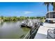 Waterfront property featuring a dock and boat for enjoying the beautiful views and canal access at 2611 San Luis Rd, Holiday, FL 34691