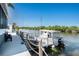 Waterfront property featuring a dock and boat for enjoying the beautiful views and canal access at 2611 San Luis Rd, Holiday, FL 34691