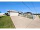 View of home's driveway and garage, complemented by a well-maintained lawn at 2611 San Luis Rd, Holiday, FL 34691