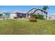 Charming single-story home featuring well-manicured lawn and lush landscaping at 2611 San Luis Rd, Holiday, FL 34691