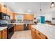 Charming kitchen boasts wood cabinets, granite counters, and modern appliances at 2611 San Luis Rd, Holiday, FL 34691