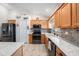 Well-equipped kitchen featuring stainless steel appliances and granite countertops at 2611 San Luis Rd, Holiday, FL 34691