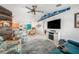 Spacious living room featuring a large TV, ceiling fan, and nautical decor at 2611 San Luis Rd, Holiday, FL 34691