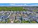 Areal view of a two-story homes featuring well-manicured lawns, backyard pools, and lush trees in a desirable neighborhood at 28809 S Orange Berry S Dr, Wesley Chapel, FL 33543