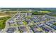 Sweeping aerial shot of a vibrant community boasting tree-lined streets, community pool, and serene pond views at 28809 S Orange Berry S Dr, Wesley Chapel, FL 33543