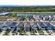 Aerial view showcases a residential community near a lake, highlighting the homes and green landscape at 28809 S Orange Berry S Dr, Wesley Chapel, FL 33543