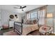Cozy bedroom with stylish decor, hardwood floors, and natural light at 28809 S Orange Berry S Dr, Wesley Chapel, FL 33543