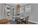 Dining area with stylish lighting, wooden table, and bright windows with natural light at 28809 S Orange Berry S Dr, Wesley Chapel, FL 33543