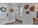 A bright entryway featuring wood flooring, neutral walls, and decorative wall baskets at 28809 S Orange Berry S Dr, Wesley Chapel, FL 33543
