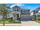 Charming two-story home with a covered front porch and a well-manicured lawn with garden at 28809 S Orange Berry S Dr, Wesley Chapel, FL 33543