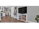Spacious living area with hardwood floors, a TV, and built-in storage at 28809 S Orange Berry S Dr, Wesley Chapel, FL 33543