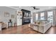 Bright living room with fireplace, built-in shelving, and a comfortable sectional sofa at 28809 S Orange Berry S Dr, Wesley Chapel, FL 33543