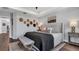 Serene main bedroom featuring a king bed, stylish decor, and wood floors at 28809 S Orange Berry S Dr, Wesley Chapel, FL 33543