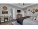 Bright main bedroom with a bed, desk, and wood floors at 28809 S Orange Berry S Dr, Wesley Chapel, FL 33543