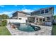 Beautiful backyard pool with waterfall feature, spa, patio, and comfortable seating area for relaxation and entertaining at 28809 S Orange Berry S Dr, Wesley Chapel, FL 33543