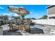 Stylish outdoor seating area with umbrella overlooking the pool, creating an inviting space for relaxation and socializing at 28809 S Orange Berry S Dr, Wesley Chapel, FL 33543