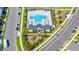 High-angle view of community pool, playground, ample parking, manicured landscape, set amidst well-maintained streets at 28809 S Orange Berry S Dr, Wesley Chapel, FL 33543